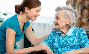 Caregiver Smiling and Meeting Senior